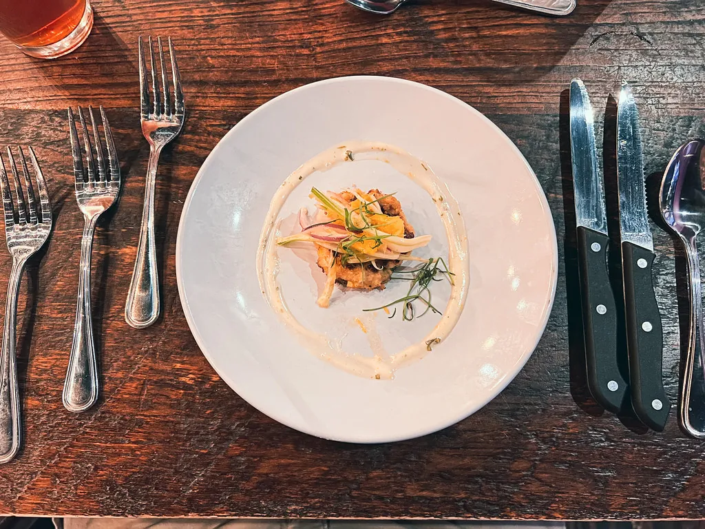 A plated course on dark wood